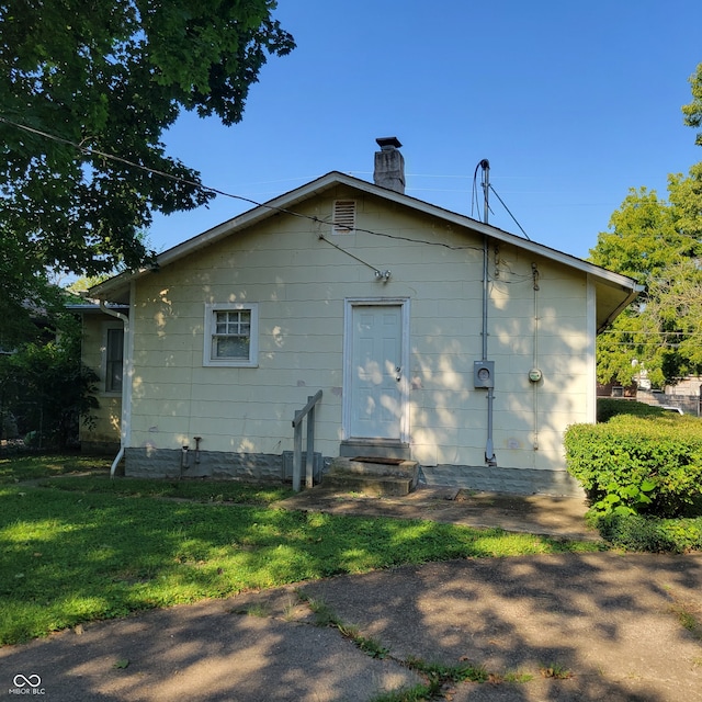 back of house with a yard