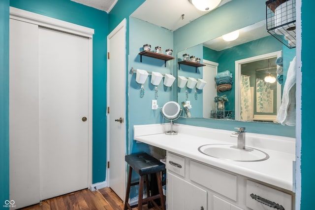 bathroom with hardwood / wood-style flooring and vanity