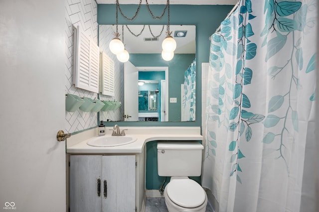 bathroom featuring vanity and toilet