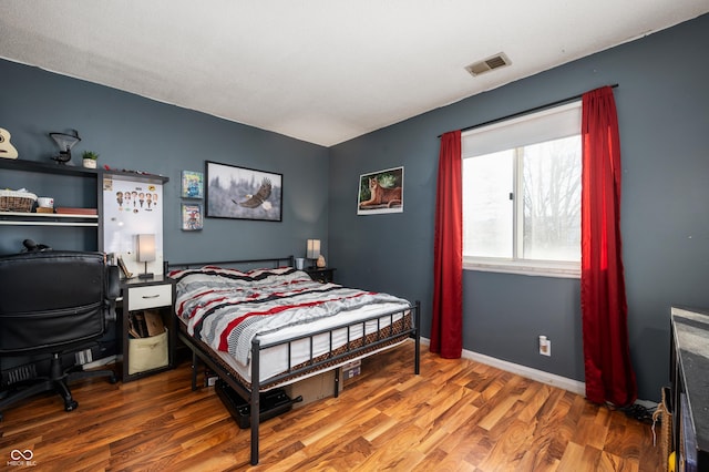 bedroom featuring wood-type flooring