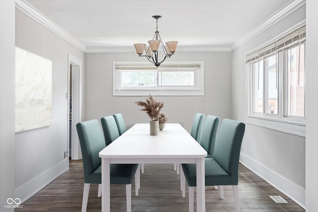 dining area featuring ornamental molding, dark hardwood / wood-style flooring, and a notable chandelier