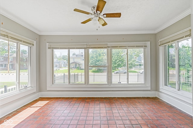 unfurnished sunroom featuring a wealth of natural light and ceiling fan