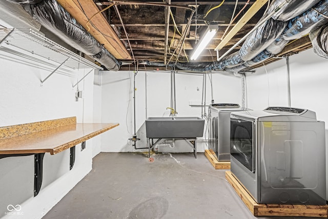 basement with washing machine and dryer and sink