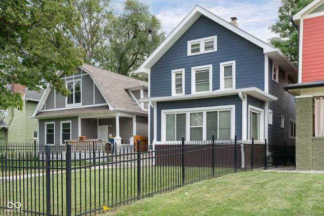 back of house with a lawn