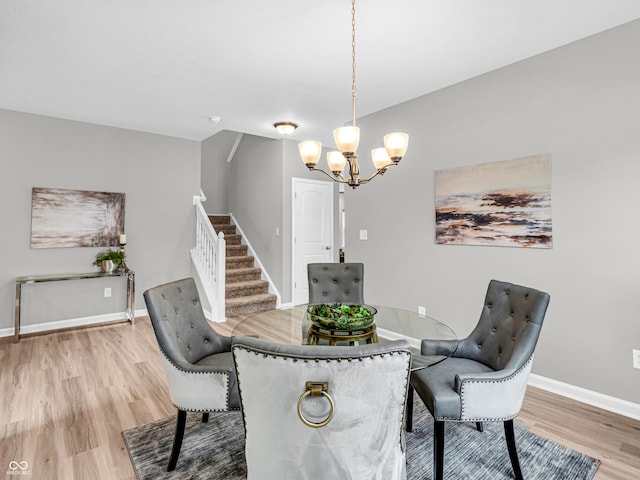 dining space with a notable chandelier and light wood-type flooring