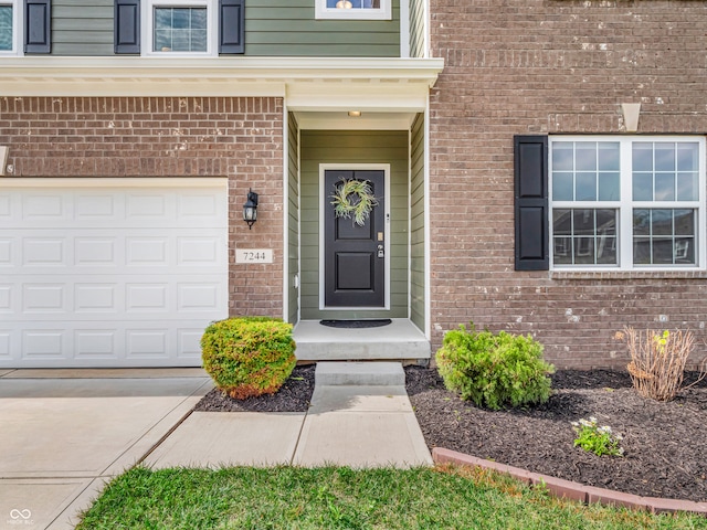 doorway to property with a garage