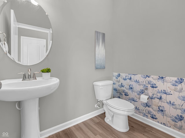 bathroom featuring hardwood / wood-style flooring and toilet