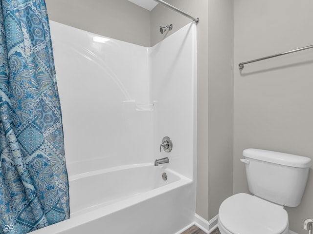 bathroom with shower / bath combo and toilet