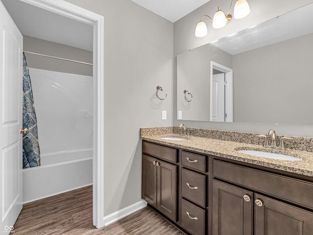 bathroom with wood-type flooring, shower / tub combo with curtain, and vanity