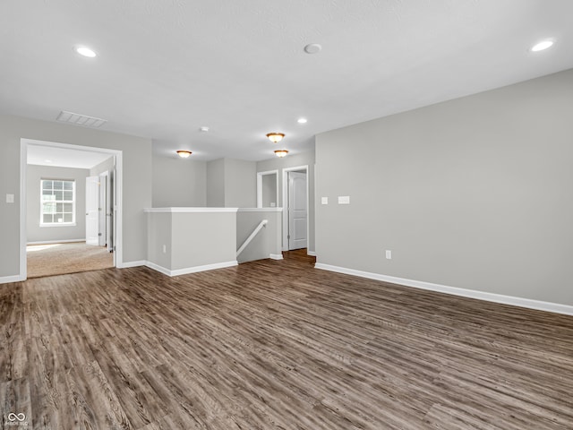 unfurnished room with dark hardwood / wood-style flooring