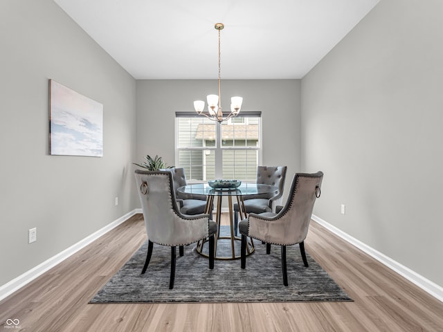 dining area with a chandelier and hardwood / wood-style flooring