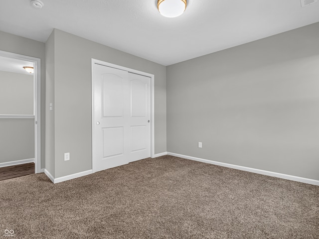 unfurnished bedroom featuring a closet and carpet floors