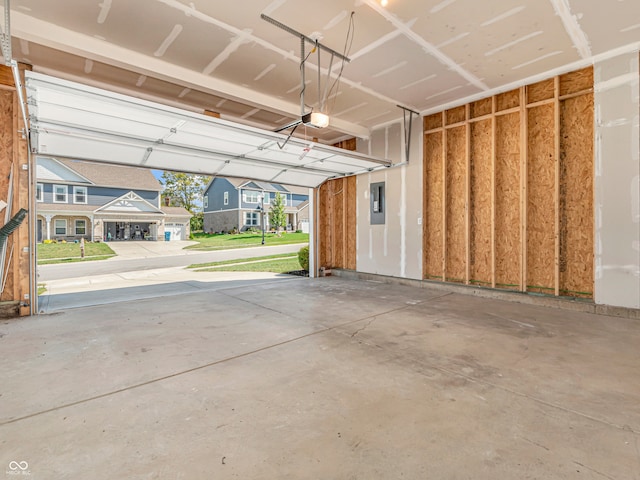 garage featuring electric panel, a garage door opener, a yard, and a carport