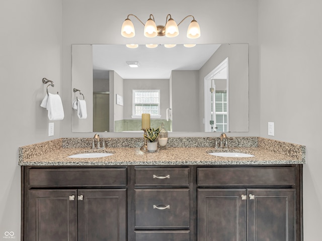 bathroom with vanity and a shower with door