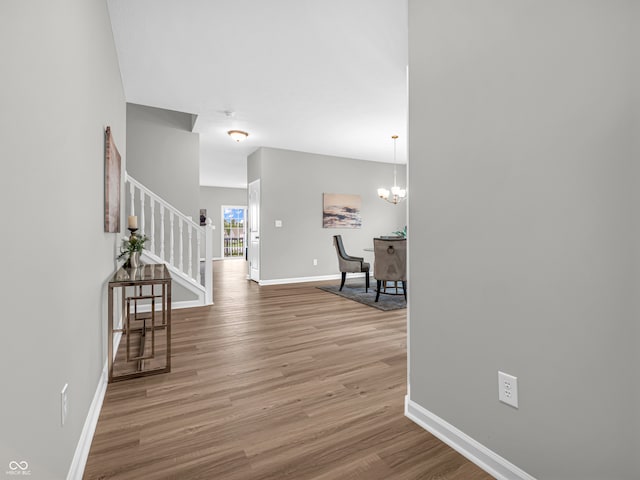 corridor with a chandelier and hardwood / wood-style flooring