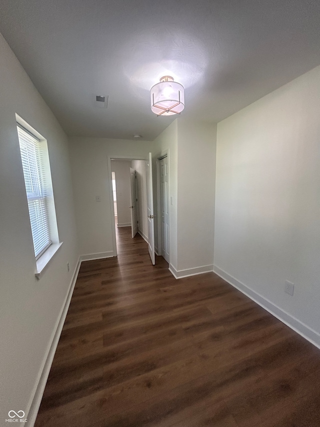 spare room featuring dark wood-type flooring