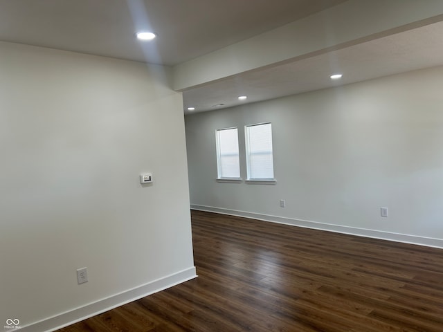 empty room with dark hardwood / wood-style floors