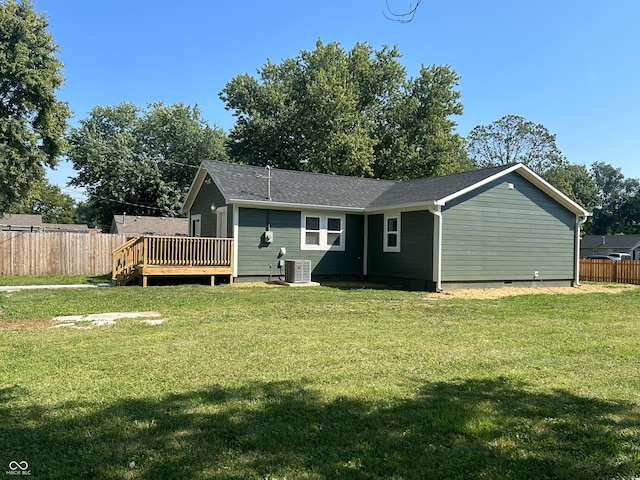 rear view of house featuring central air condition unit, a yard, and a deck