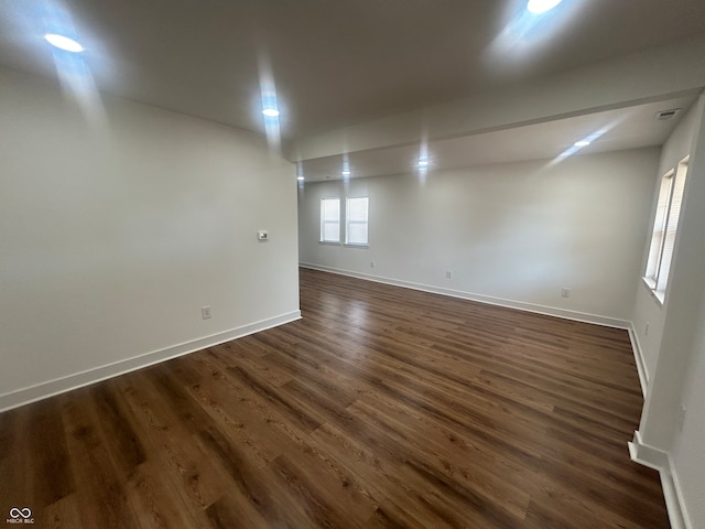 unfurnished room with dark hardwood / wood-style flooring