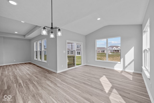 unfurnished living room with light hardwood / wood-style floors and vaulted ceiling