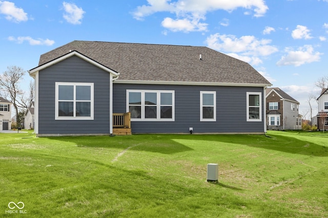 rear view of house featuring a yard