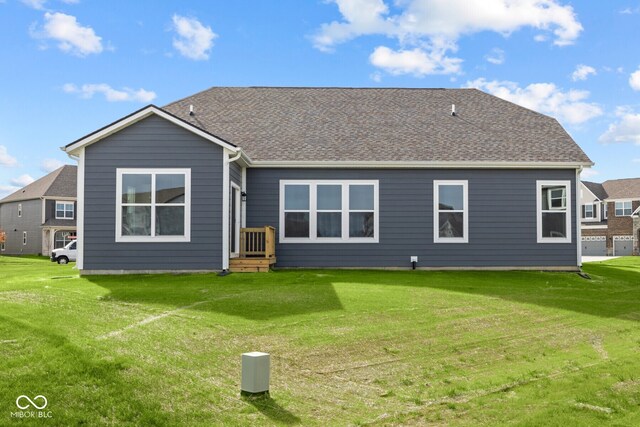 rear view of house featuring a yard