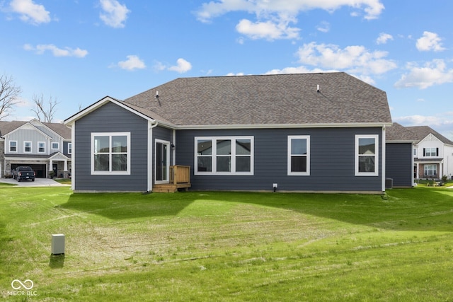 rear view of house featuring a yard