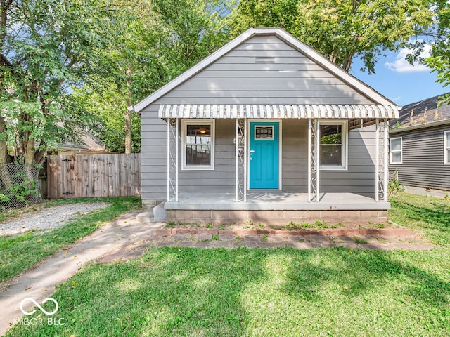 bungalow featuring a front lawn and covered porch