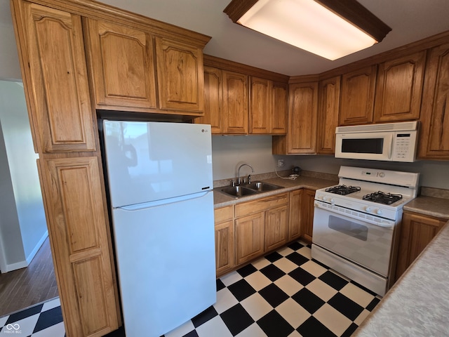 kitchen featuring sink, white appliances, and light tile patterned floors