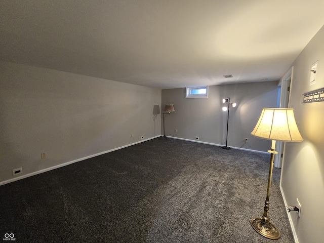 interior space featuring visible vents, baseboards, and dark colored carpet