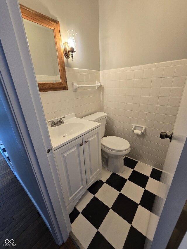 bathroom with tile walls, tile patterned flooring, tasteful backsplash, and toilet