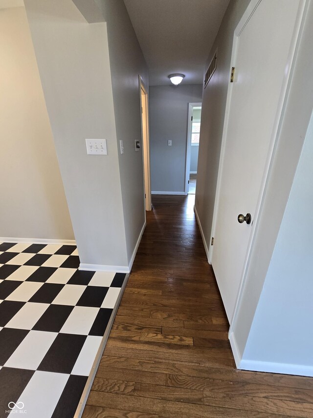 hallway with dark hardwood / wood-style floors