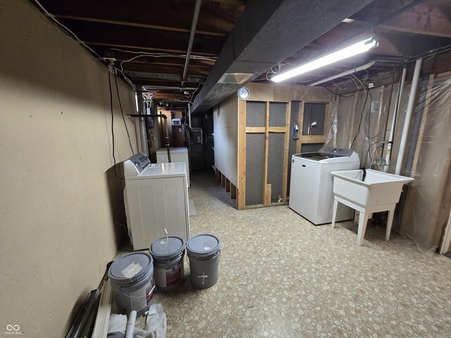 basement with sink and washer and clothes dryer