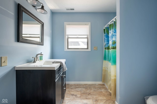 bathroom with a shower with shower curtain, vanity, and toilet