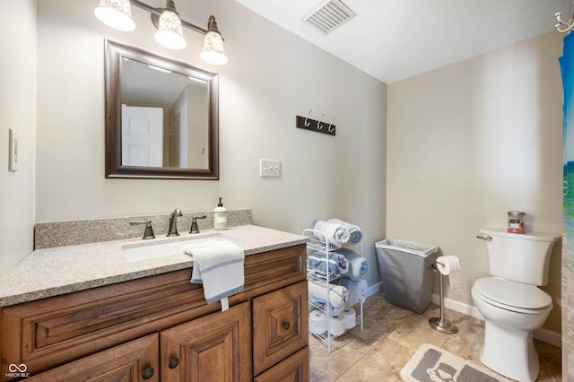 9235 N Gray Ave, Unionville, IN 47468 - bathroom featuring toilet, vanity, visible vents, and baseboards