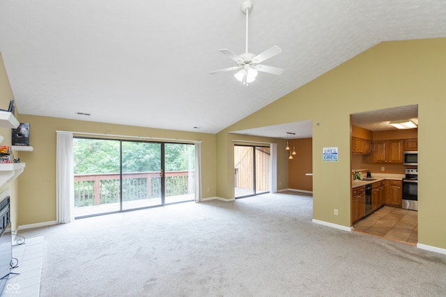 carpeted living room with a textured ceiling, high vaulted ceiling, sink, and ceiling fan