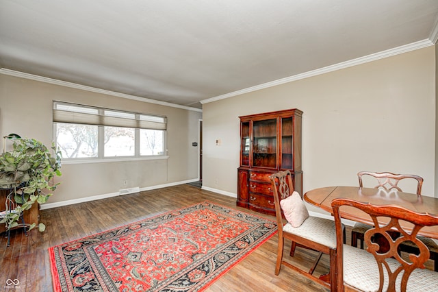 dining room featuring dark hardwood / wood-style flooring and crown molding