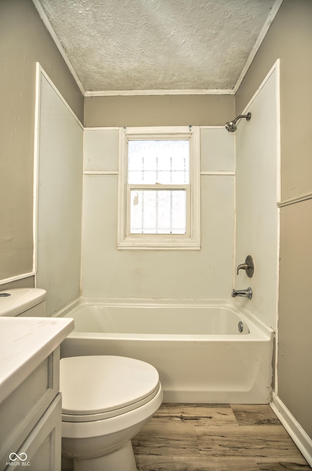 bathroom featuring vanity, toilet, wood finished floors, and a textured ceiling