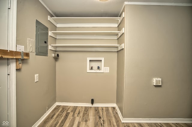 washroom featuring baseboards, electric panel, laundry area, hookup for a washing machine, and wood finished floors