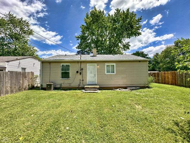 back of property with a lawn