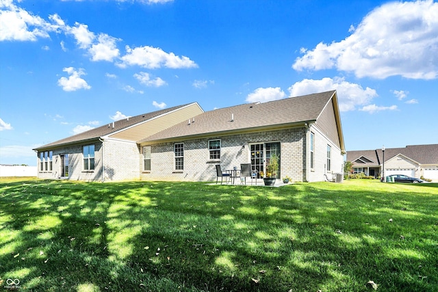 rear view of house with a patio area, central AC, a lawn, and brick siding