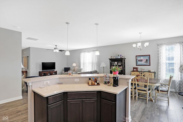 kitchen with open floor plan, light countertops, wood finished floors, and a healthy amount of sunlight