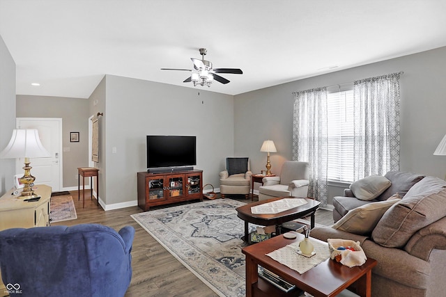 living area with ceiling fan, wood finished floors, and baseboards