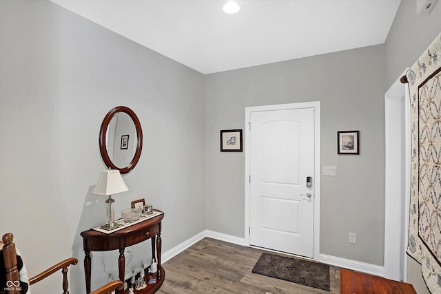 entrance foyer featuring baseboards and wood finished floors