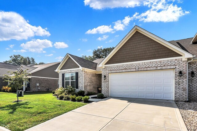 view of front of home with a front yard and a garage