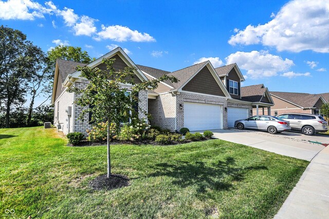 view of front of house with a garage and a front lawn