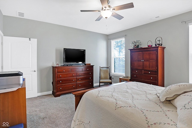 bedroom featuring carpet floors, visible vents, baseboards, and a ceiling fan