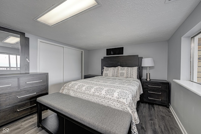 7587 Shady Side Dr, Bloomington, IN 47401 - bedroom featuring a closet, wood finished floors, and a textured ceiling