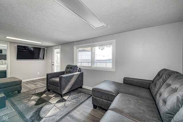 living room featuring a textured ceiling and hardwood / wood-style floors