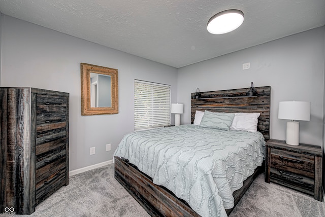 bedroom with carpet flooring and a textured ceiling